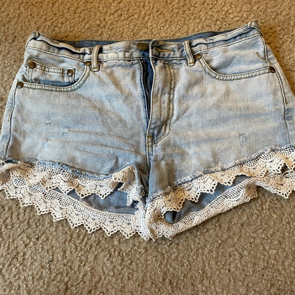 Free people jean shorts with lace detail